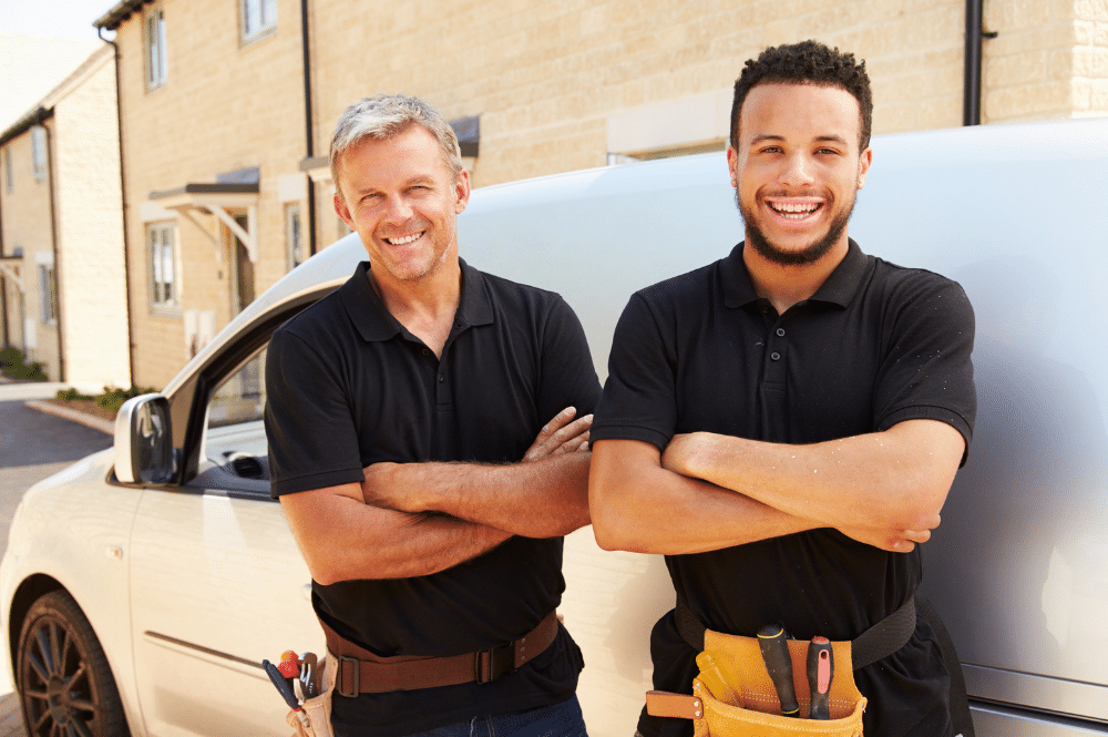 two people standing in front of a white van with their arms crossed