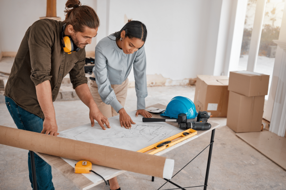 two people looking at building plans