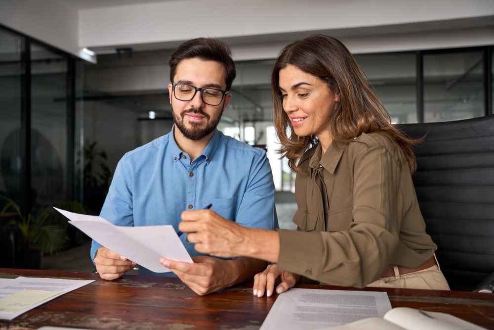 Smiling female financial advisor with client